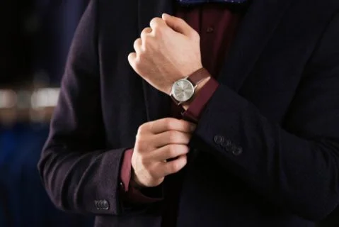 Young man in elegant suit on blurred background