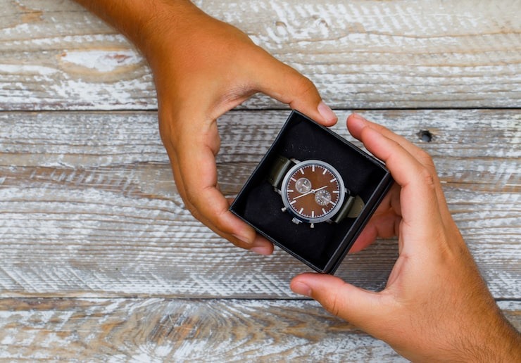 Hands holding a watch in box
