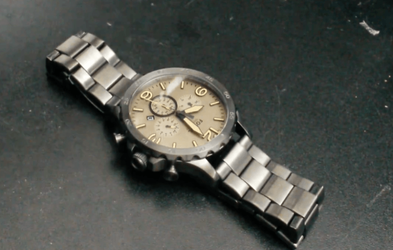 Metal watch with a brown face