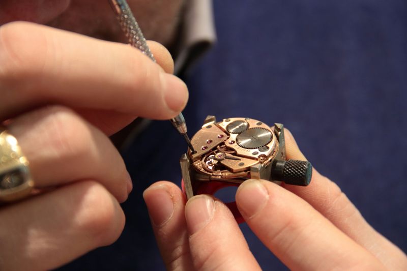 Person repairing a watch movement.